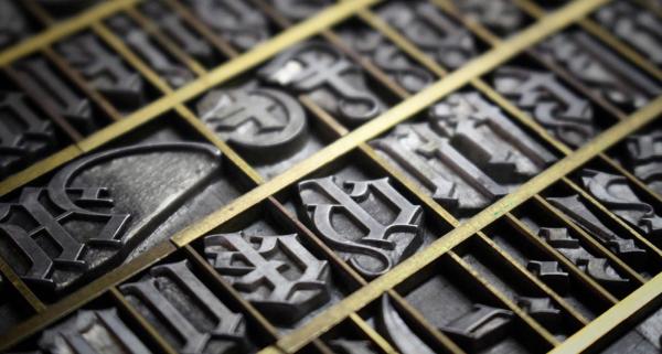 Reviving a blackletter font from 1916 using brass borders